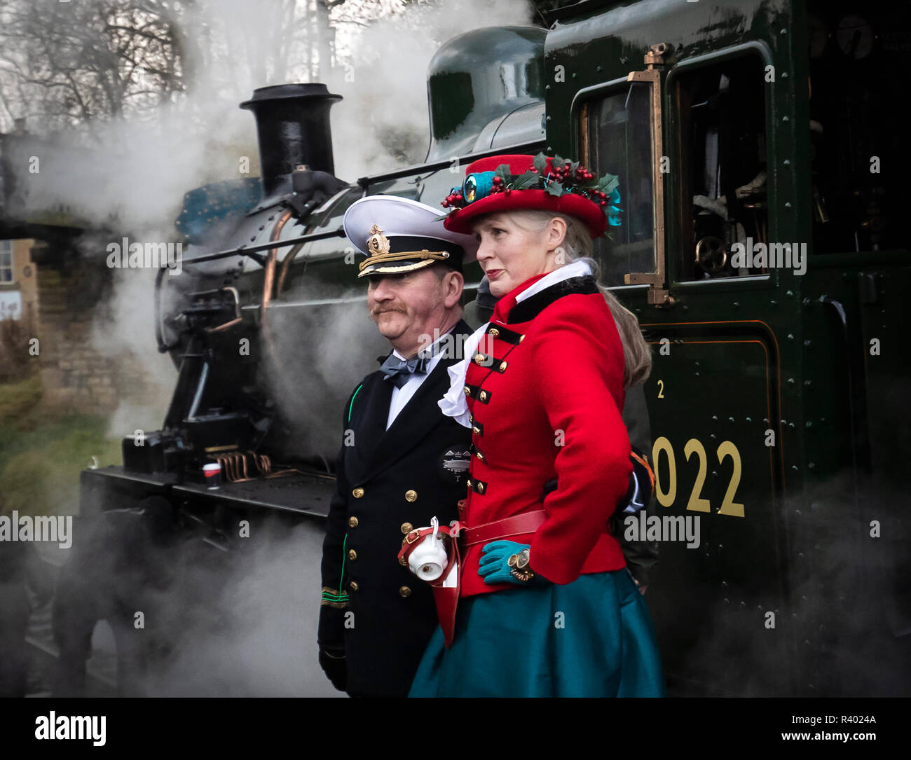 Steampunks next to a steam locomotive during the Haworth Steampunk Weekend, as hundreds of Steampunks descend on the quite village of Haworth in the Pennine hills of West Yorkshire, England. Stock Photo