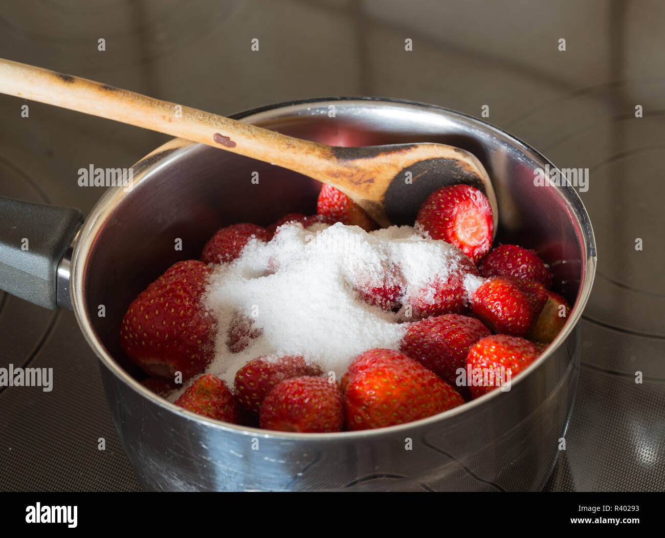strawberry jam cooking adding the sugar Stock Photo Alamy