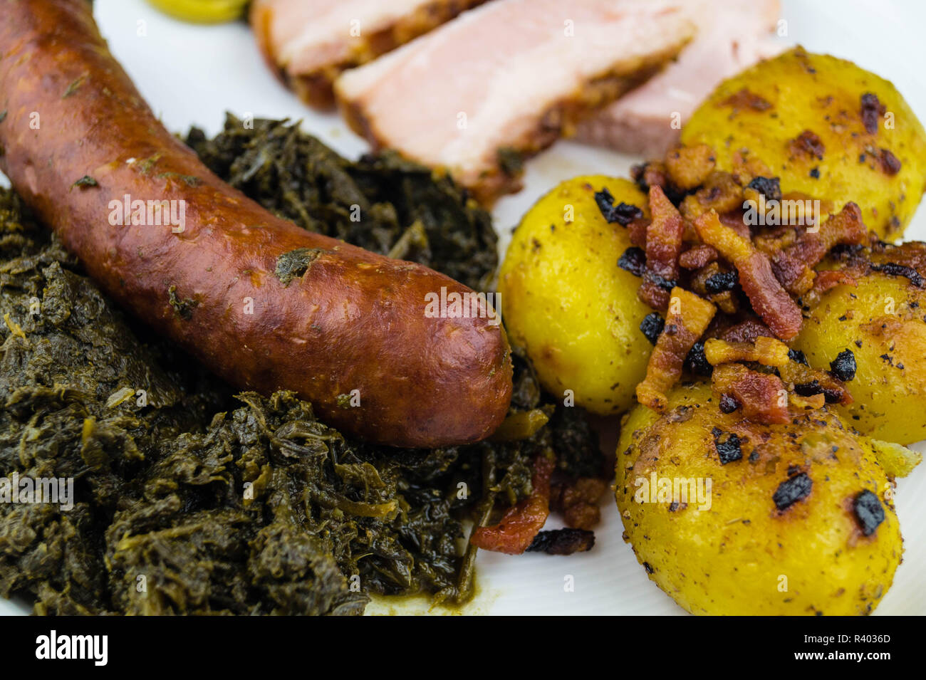 traditional northern german Food curly Kale with pork Bacon and sausages Stock Photo