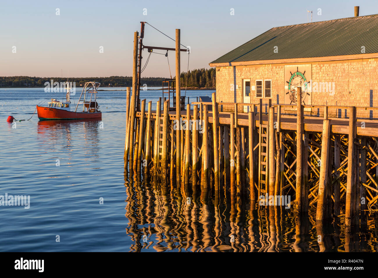 The dock and processing building at Moosabec Mussels in Jonesport, Maine. Owner Ralph Smith's mussel harvesting boat is in the distance. Stock Photo