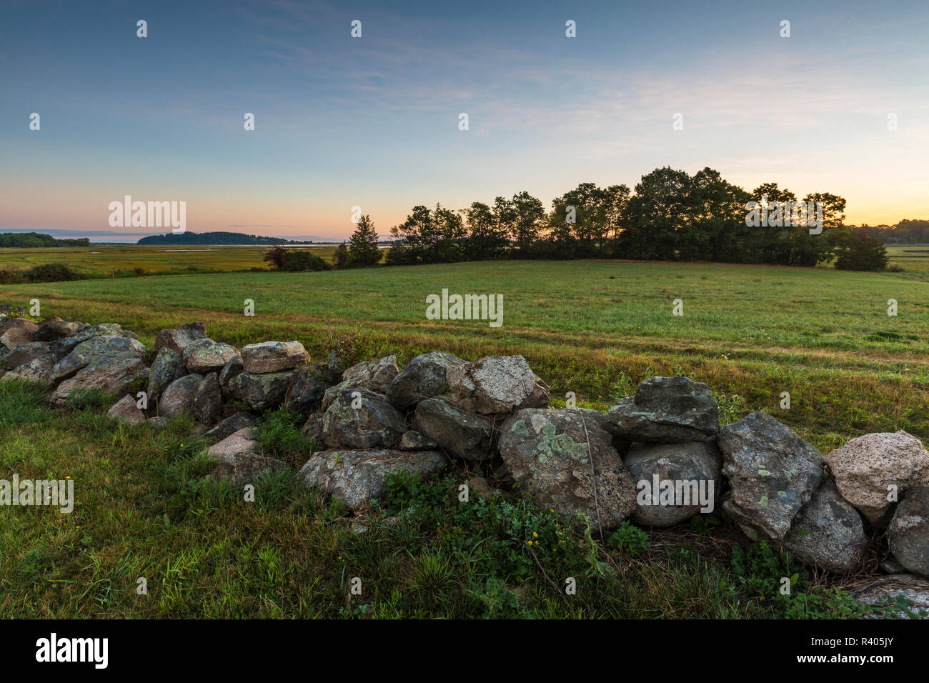A stone wall and field at the Cox Reservation in Essex, Massachusetts. Stock Photo