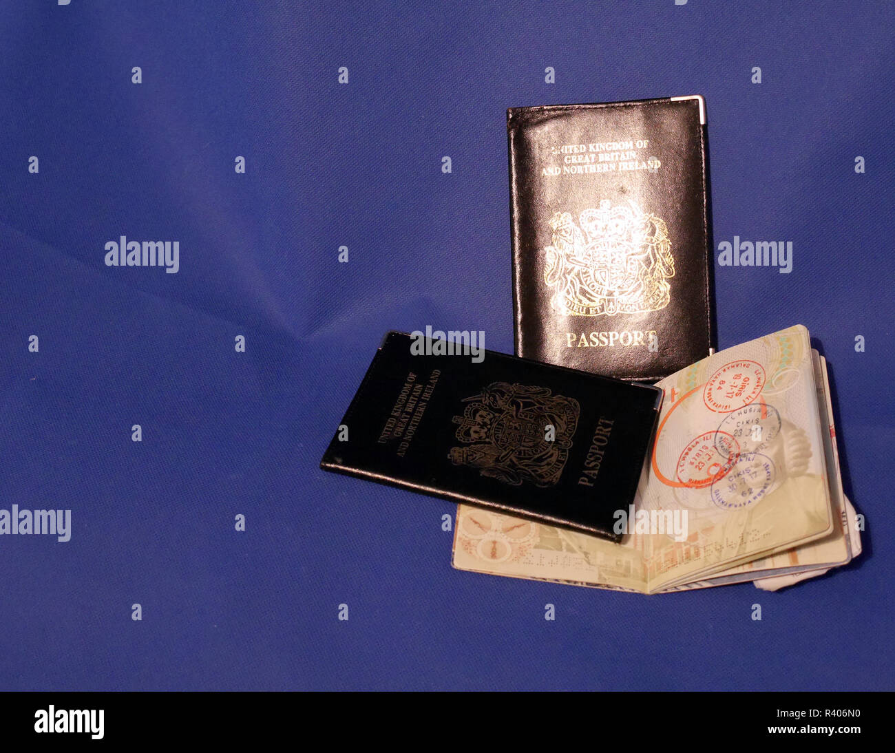 Multiple Passports. A selection of passports and holders showing pages