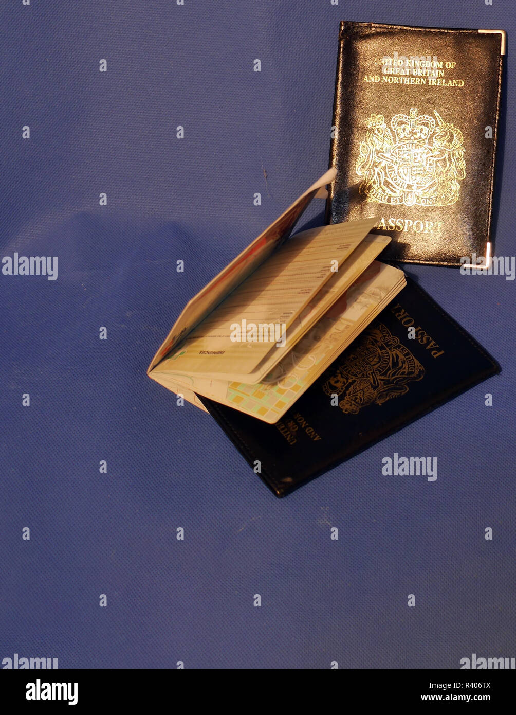 Multiple Passports. A selection of passports and holders showing pages
