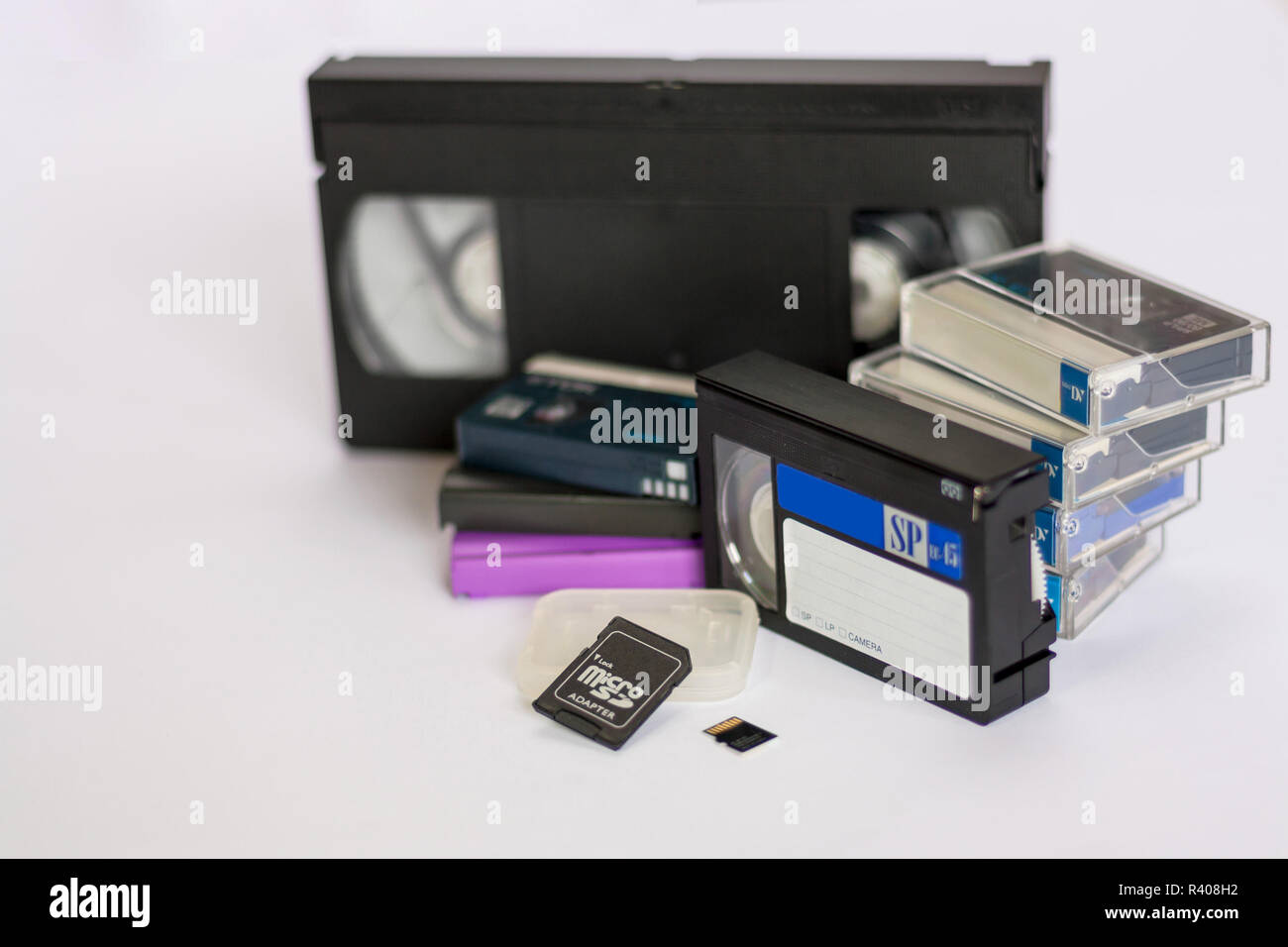 Mini dv and VHS video tape isolated on white. SD and MicroSD cards