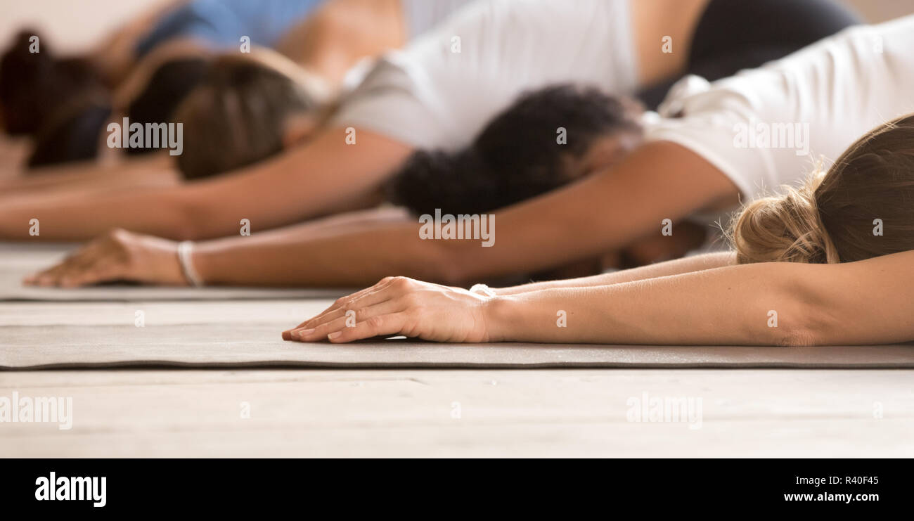 Group of women practicing yoga lesson, Child exercise close up Stock Photo