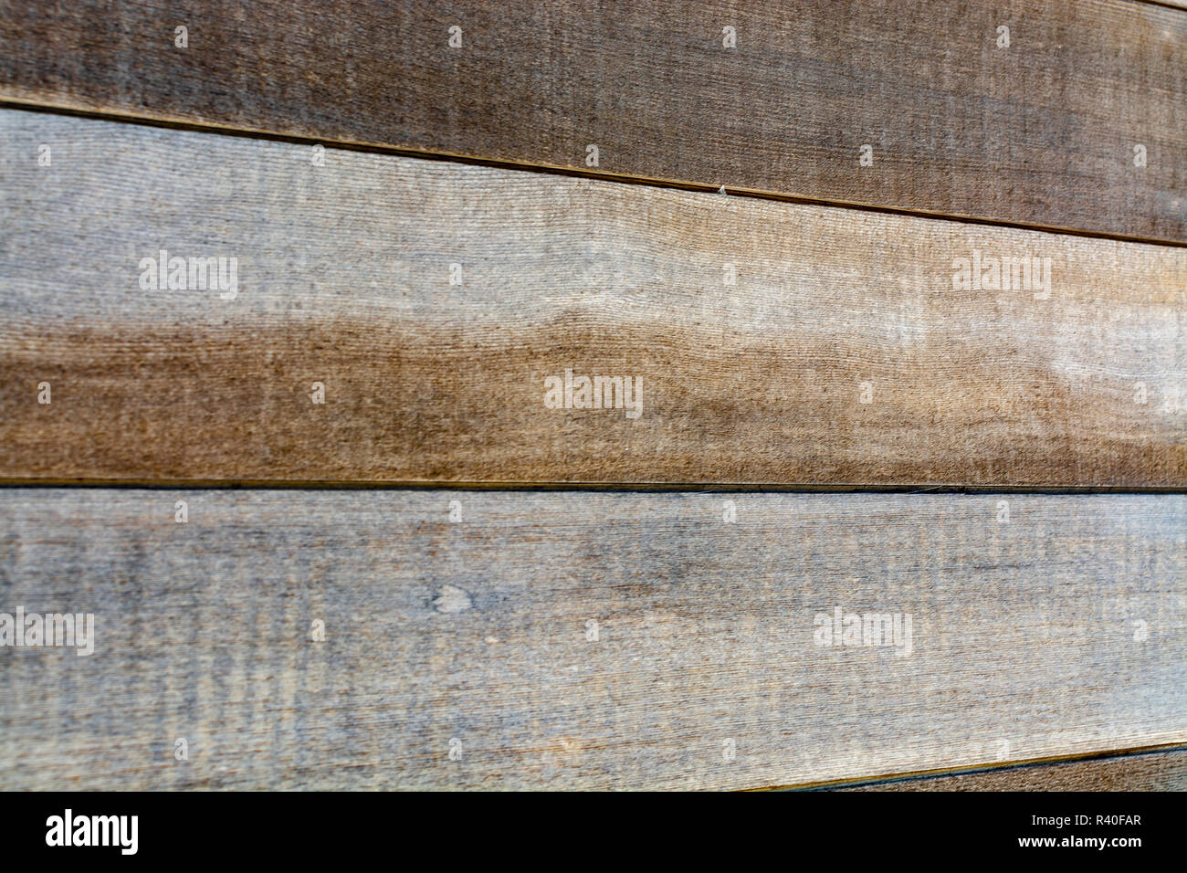 Background texture of rustic brown natural hardwood with a distinctive wood grain pattern for use a design template in a full frame landscape view Stock Photo