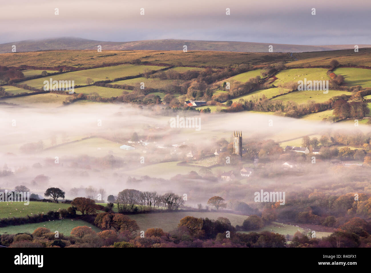 Mist in the valley agt Widecombe in the Moor, Dartmoor, England Stock Photo