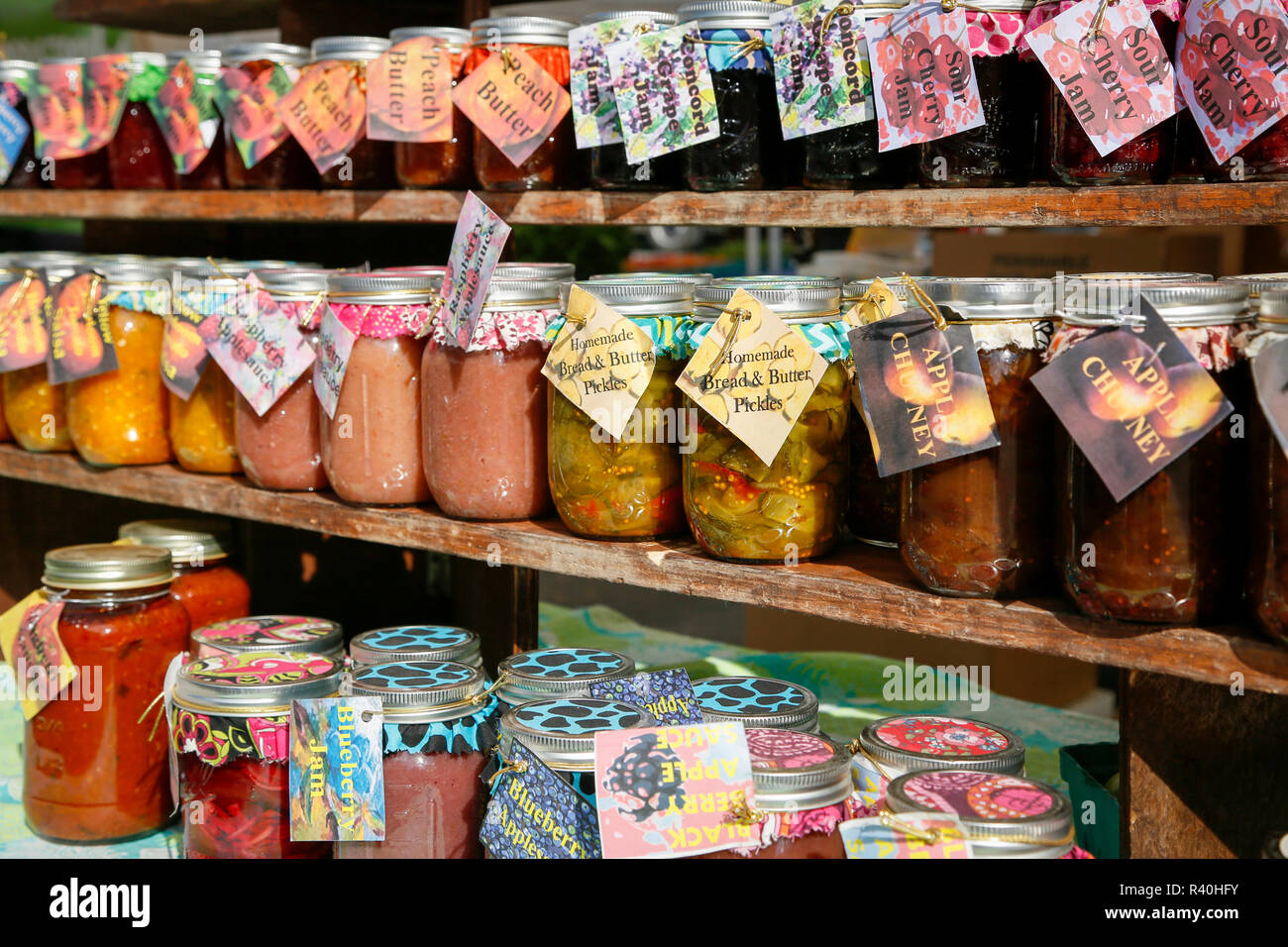 Homemade pickled vegetables and canned fruit at a farmers market, Woodstock, New York, USA. Stock Photo