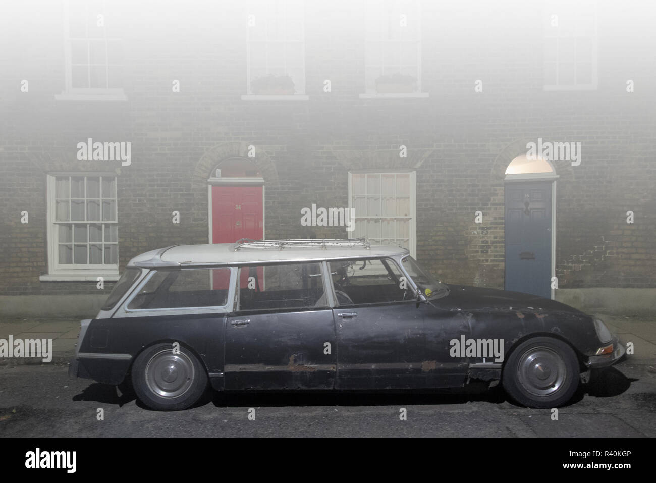 A vintage Citroen DS Wagon outside a house in a street in London in thick fog Stock Photo
