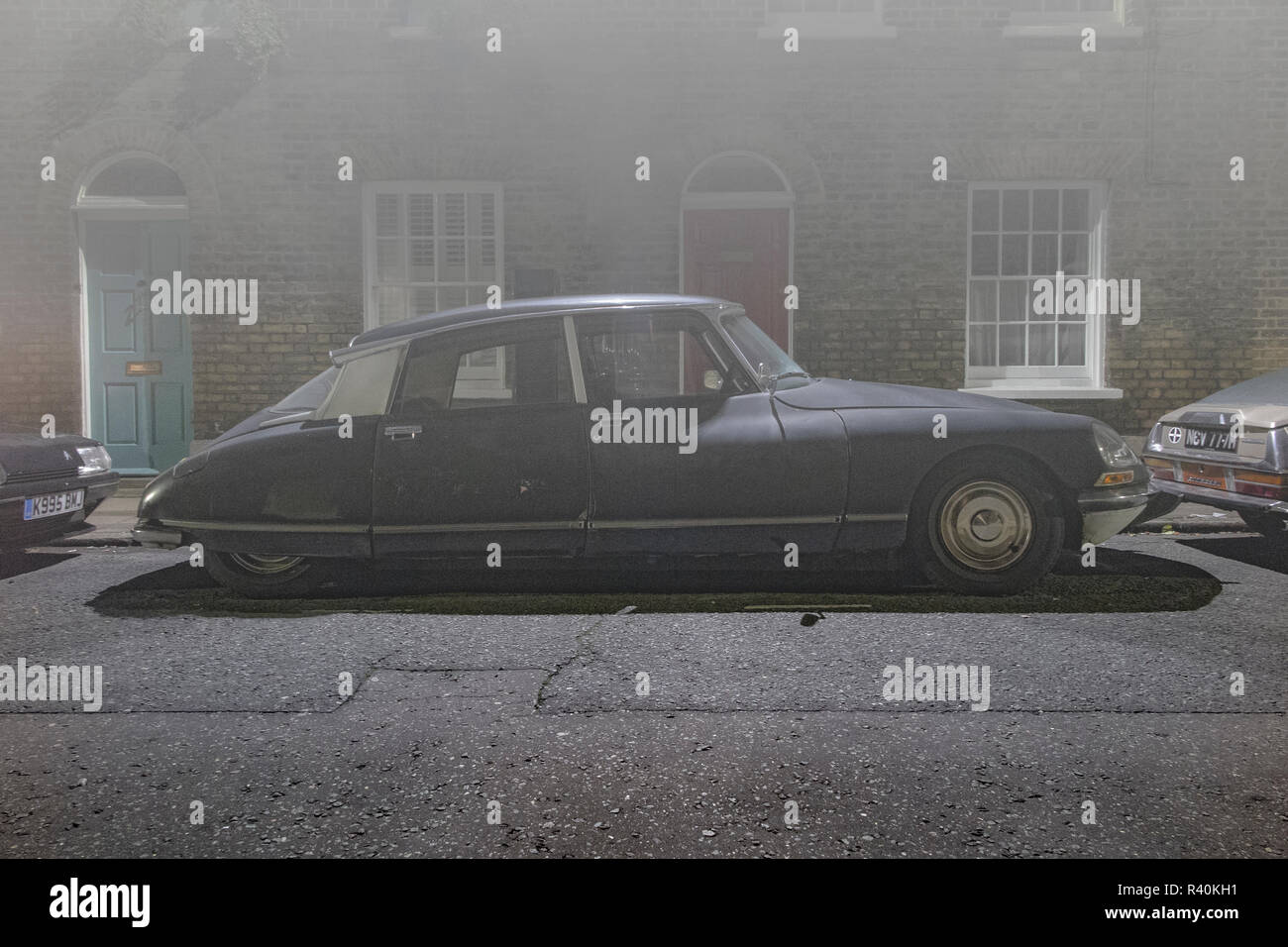 A vintage Citroen DS outside a house in a street in London in thick fog Stock Photo