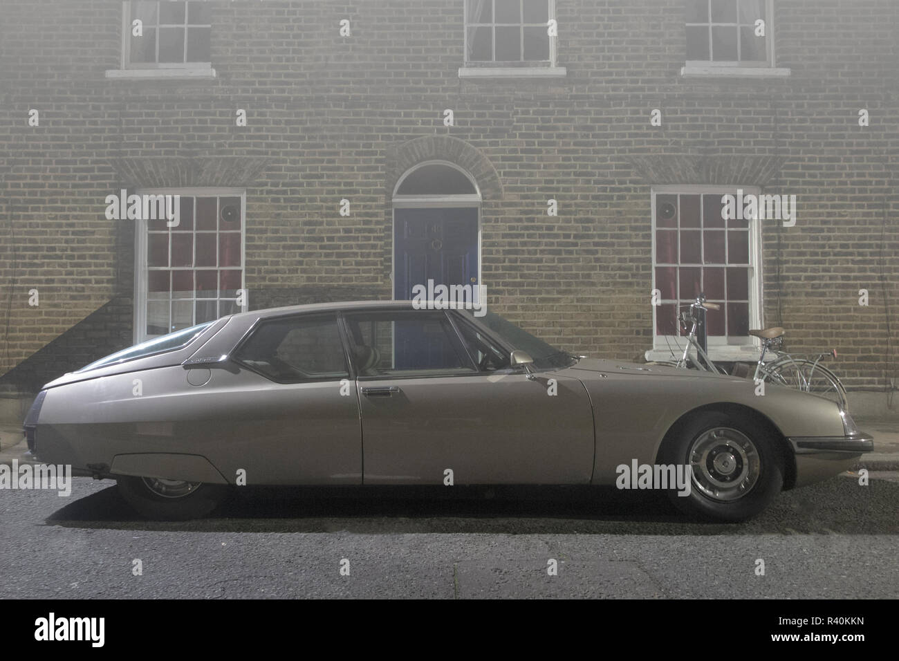 A vintage Citroen SM outside a house in a street in London in thick fog Stock Photo