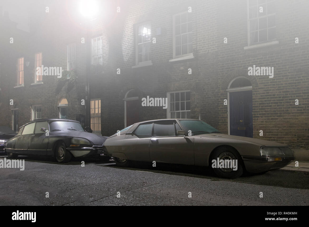 Vintage Citroens - an SM and a DS outside a house in a street in London in thick fog Stock Photo