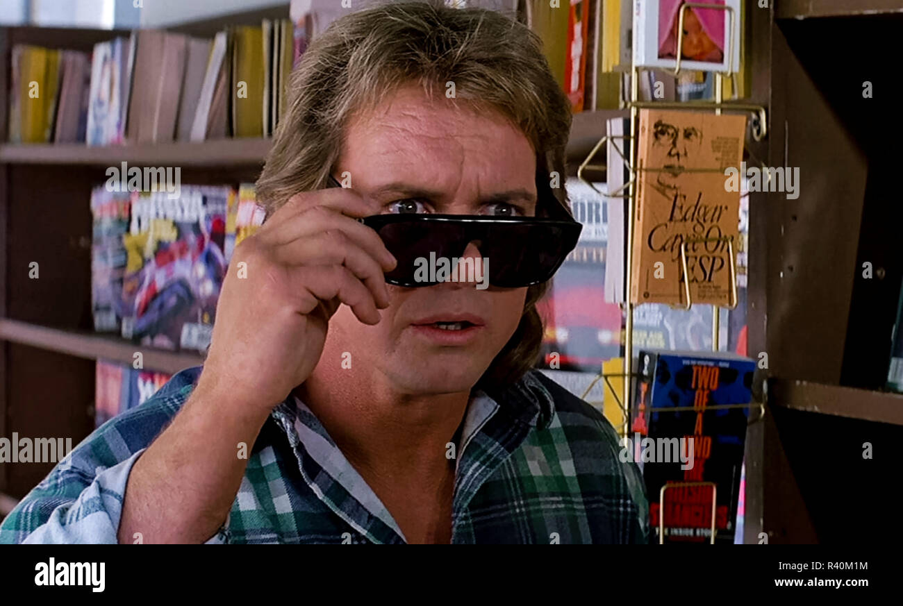Nada tries on the Hoffman lenses and sees reality for the first time, from They Live (1988) directed by John Carpenter. An unnamed drifter finds a pair of sunglasses that reveal the truth of the world and how it manipulates and rewards its inhabitants. Stock Photo