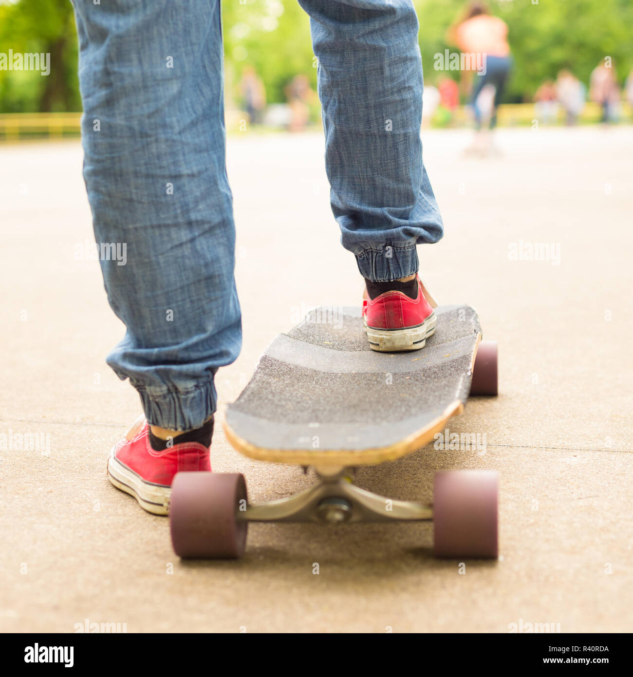 Teenage girl practicing riding long board. Stock Photo