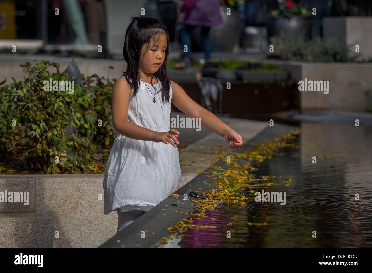 Girl playing in fountain hi-res stock photography and images - Alamy