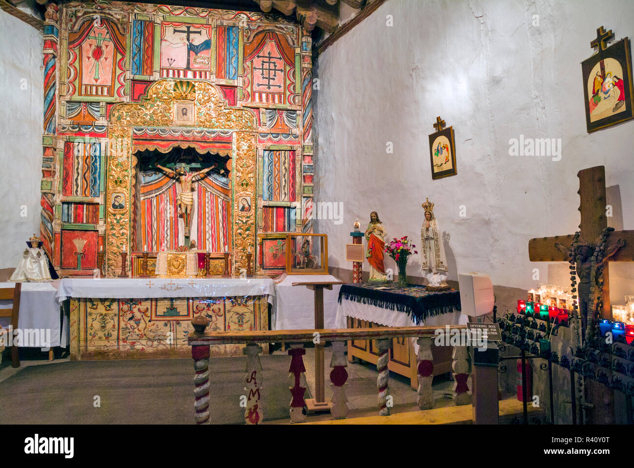 USA, New Mexico, Chimayo. The wooden altar in El Santuario de Chimayo is a Roman Catholic church which became a National Historic Landmark. Stock Photo