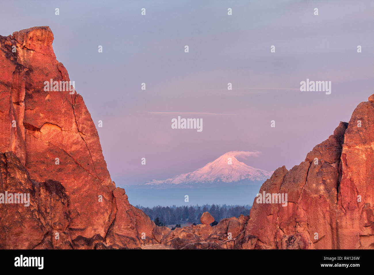 Mt. Jefferson viewed at sunrise through Asterisk Pass, Smith Rock State Park, Oregon Stock Photo