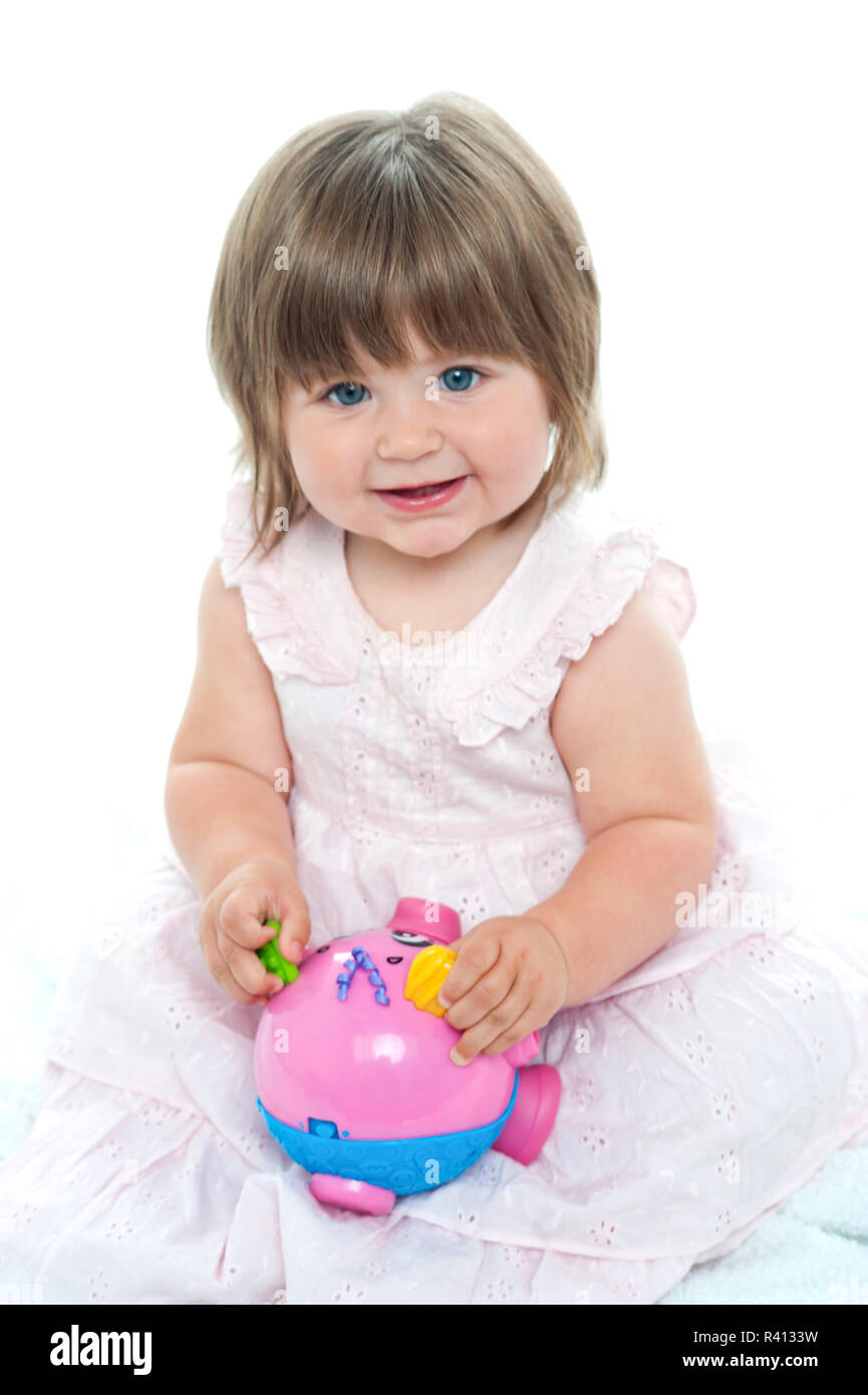 Little girl playing with toy Stock Photo - Alamy