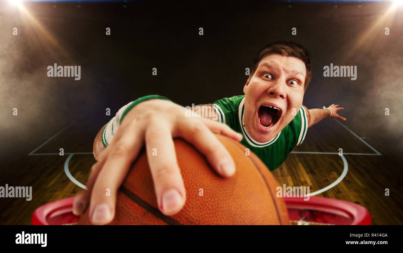 Crazy basketball player throws the ball, view from basket. Athlete in
