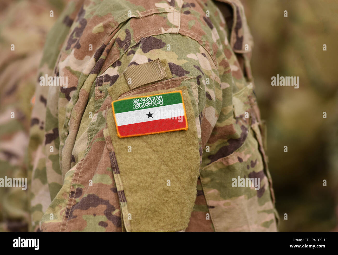 Somaliland flag on soldiers arm (collage). Stock Photo
