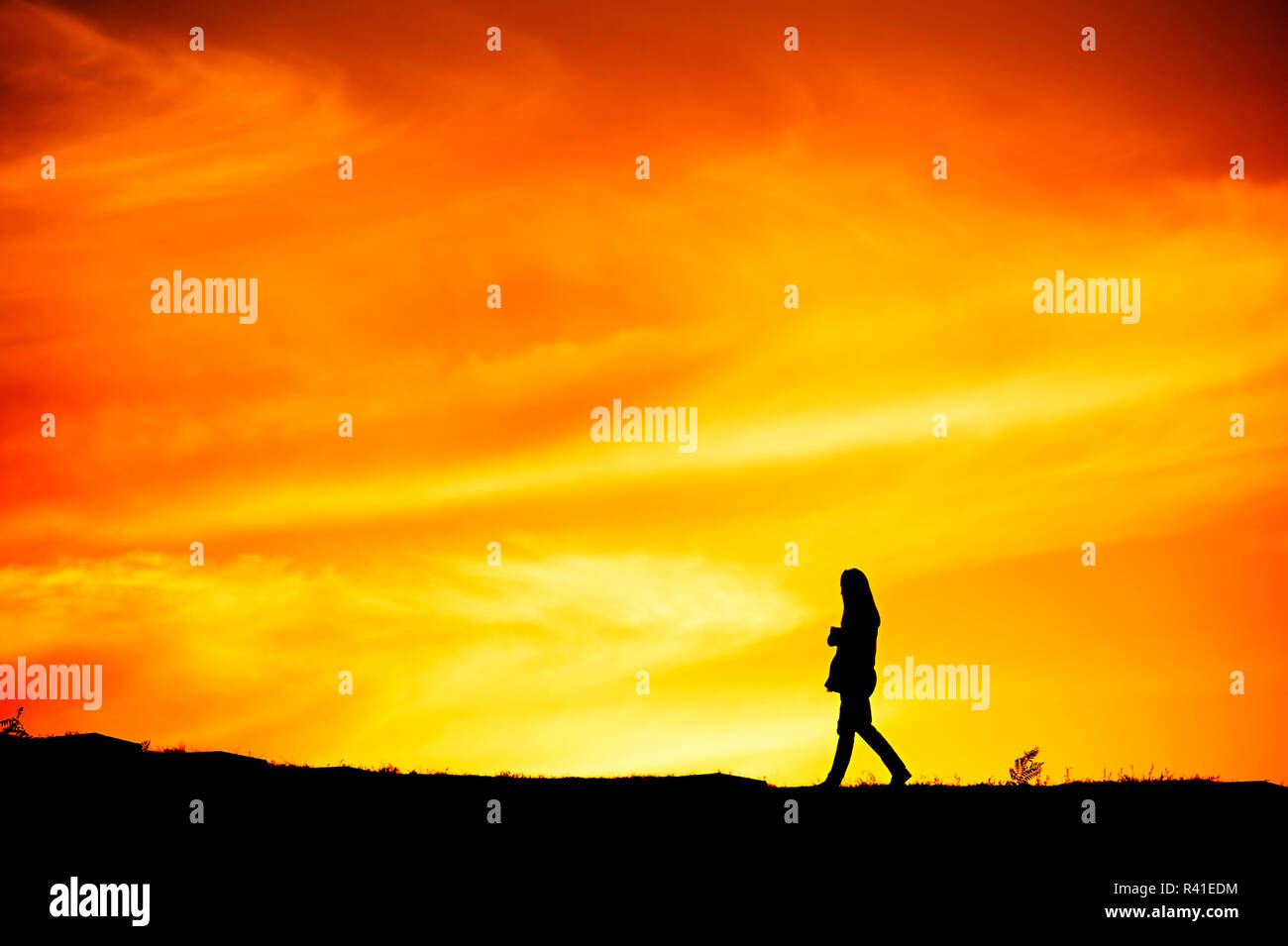 Silhouette lonely woman walking sunset hi-res stock photography and ...