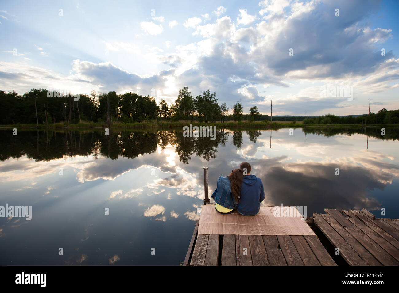 Lovers Sitting On The River Bank At Sunset Stock Photo Alamy
