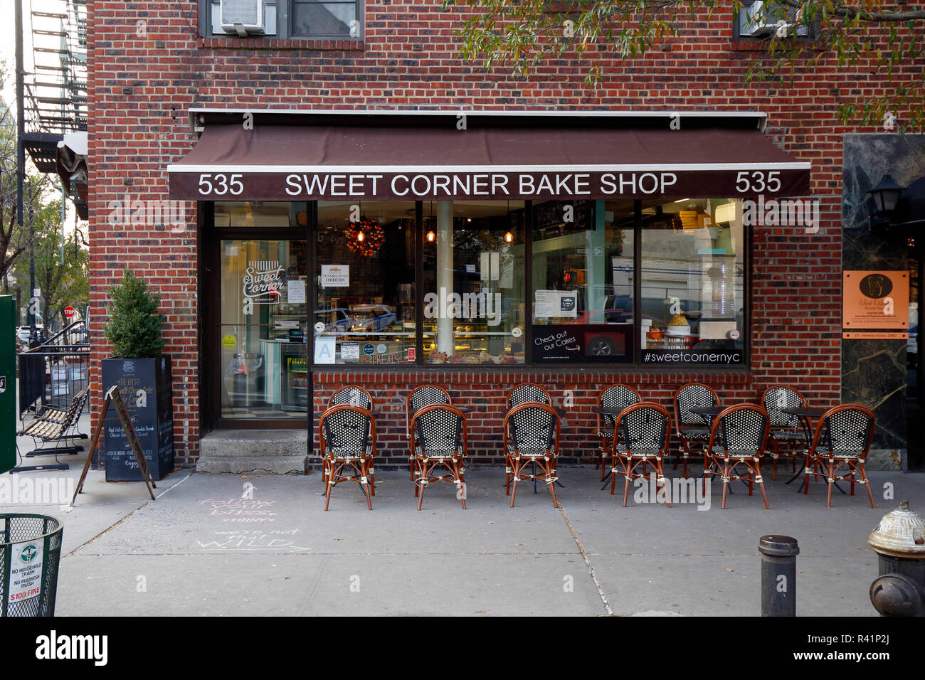 [historical storefront] Sweet Corner Bakeshop, 535 Hudson St, New York, NY. exterior of a brazilian bakery, and sidewalk cafe in the West Village Stock Photo