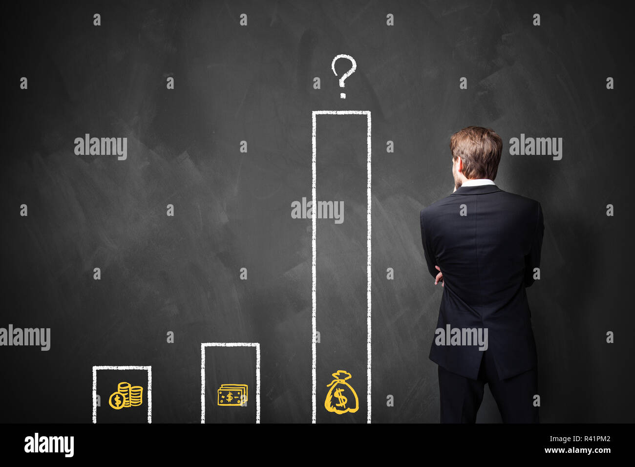 businessman standing in front of a blackboard with a chart about