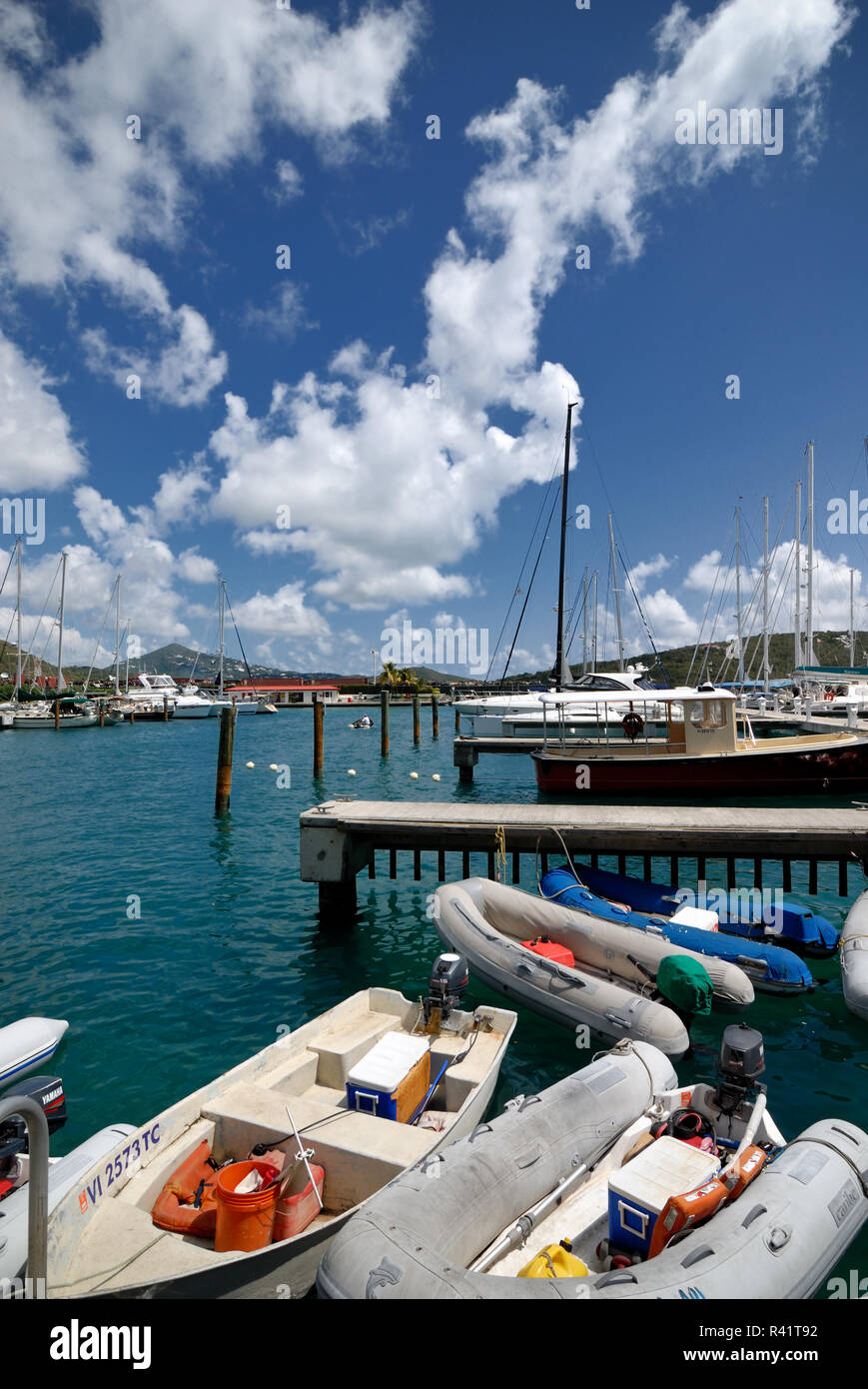 Motorboats and larger boats are docked at a Marina, St. Thomas, US