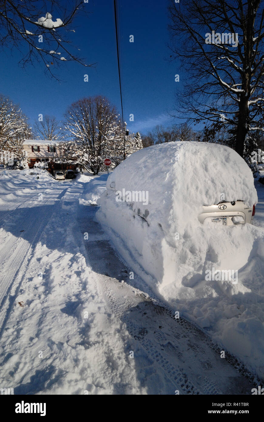 A van is completely covered in a deep pile of snow. Stock Photo