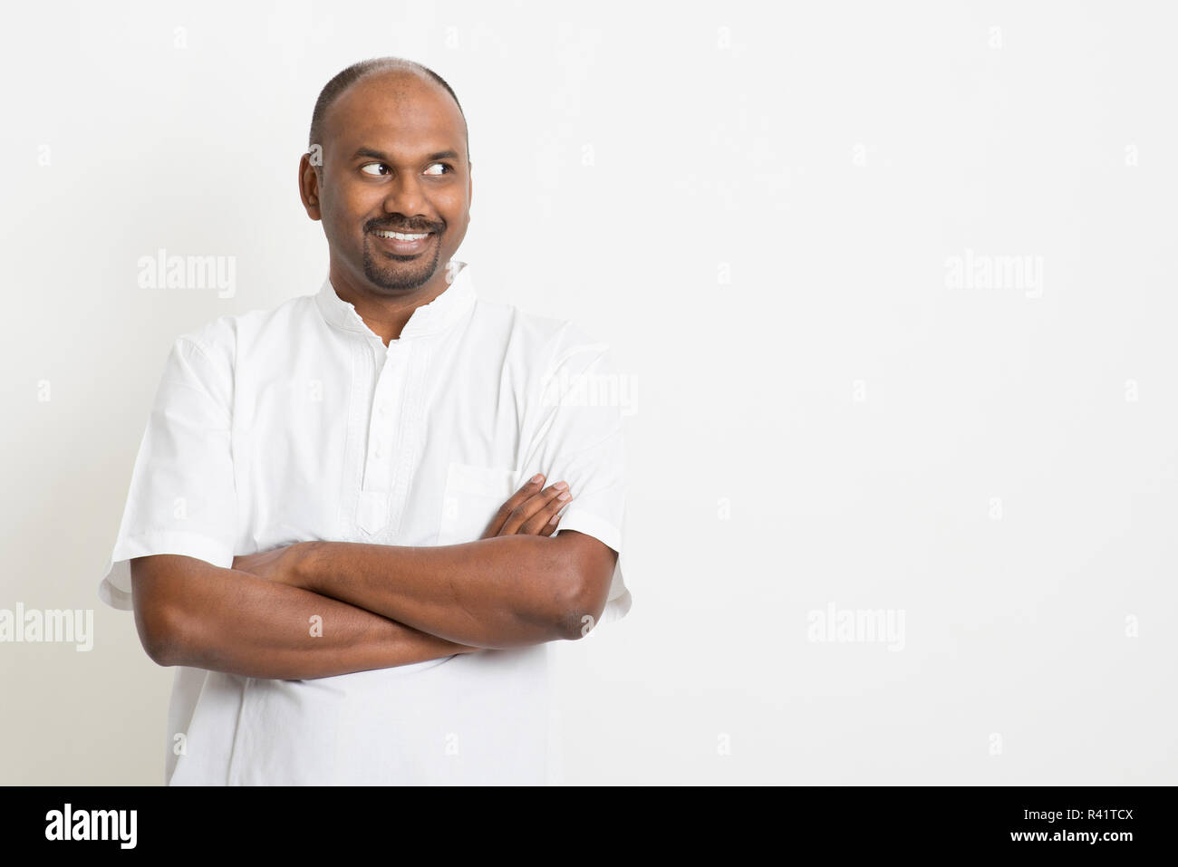 Mature Indian man looking side and smiling Stock Photo - Alamy