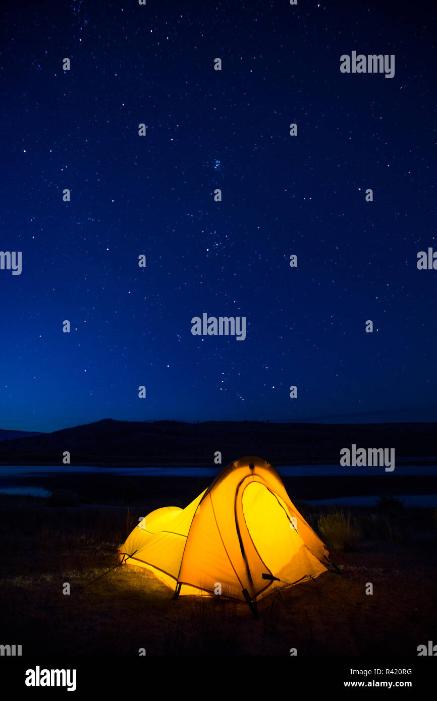 USA, Wyoming, Sublette County. Soda Lake, a tent is lit up against a starry night during a camping trip at Soda Lake. Stock Photo