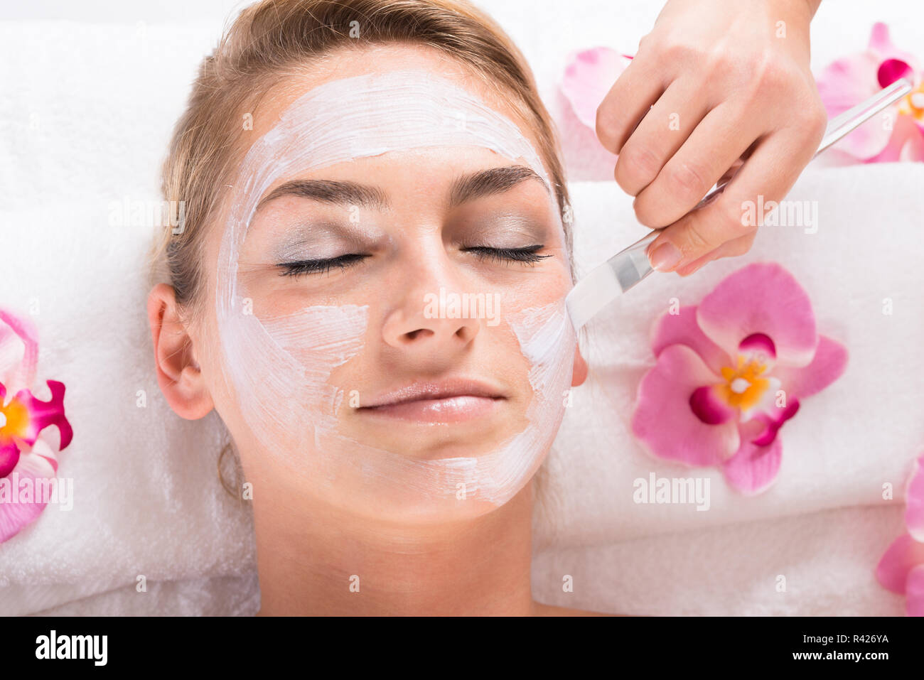 Persons hand applying facial cream hi-res stock photography and images ...