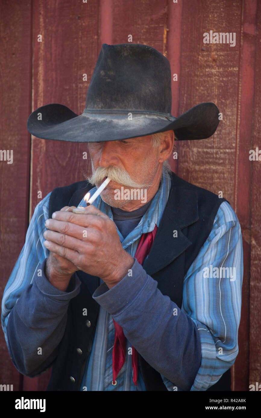 Usa, Wyoming, Shell, The Hideout Ranch, Cowboy Lighting a Cigarette (MR, PR) Stock Photo