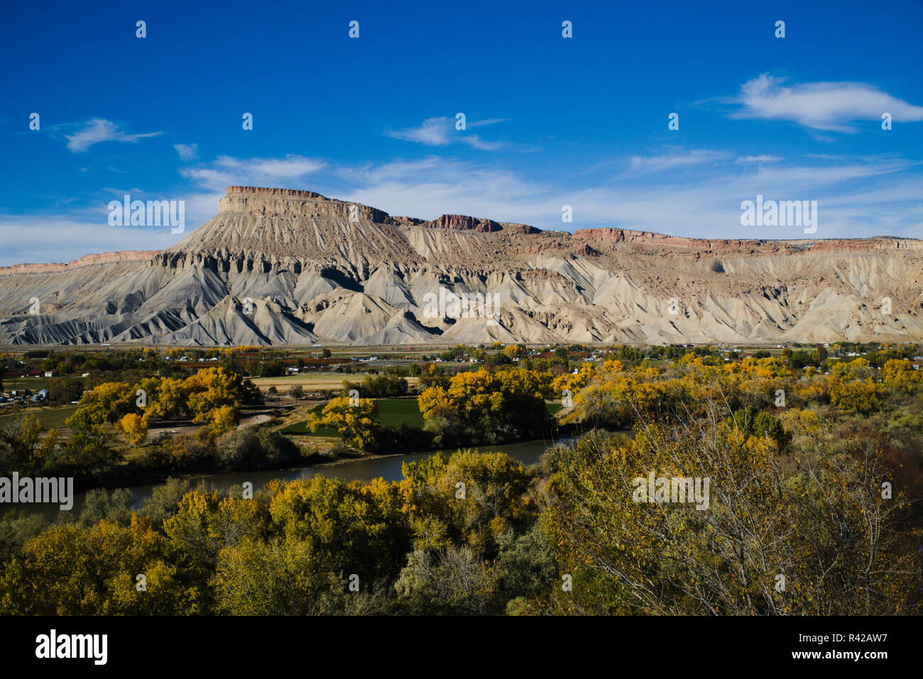 Mount Garfield up against a blue sky with the town of Palisade below