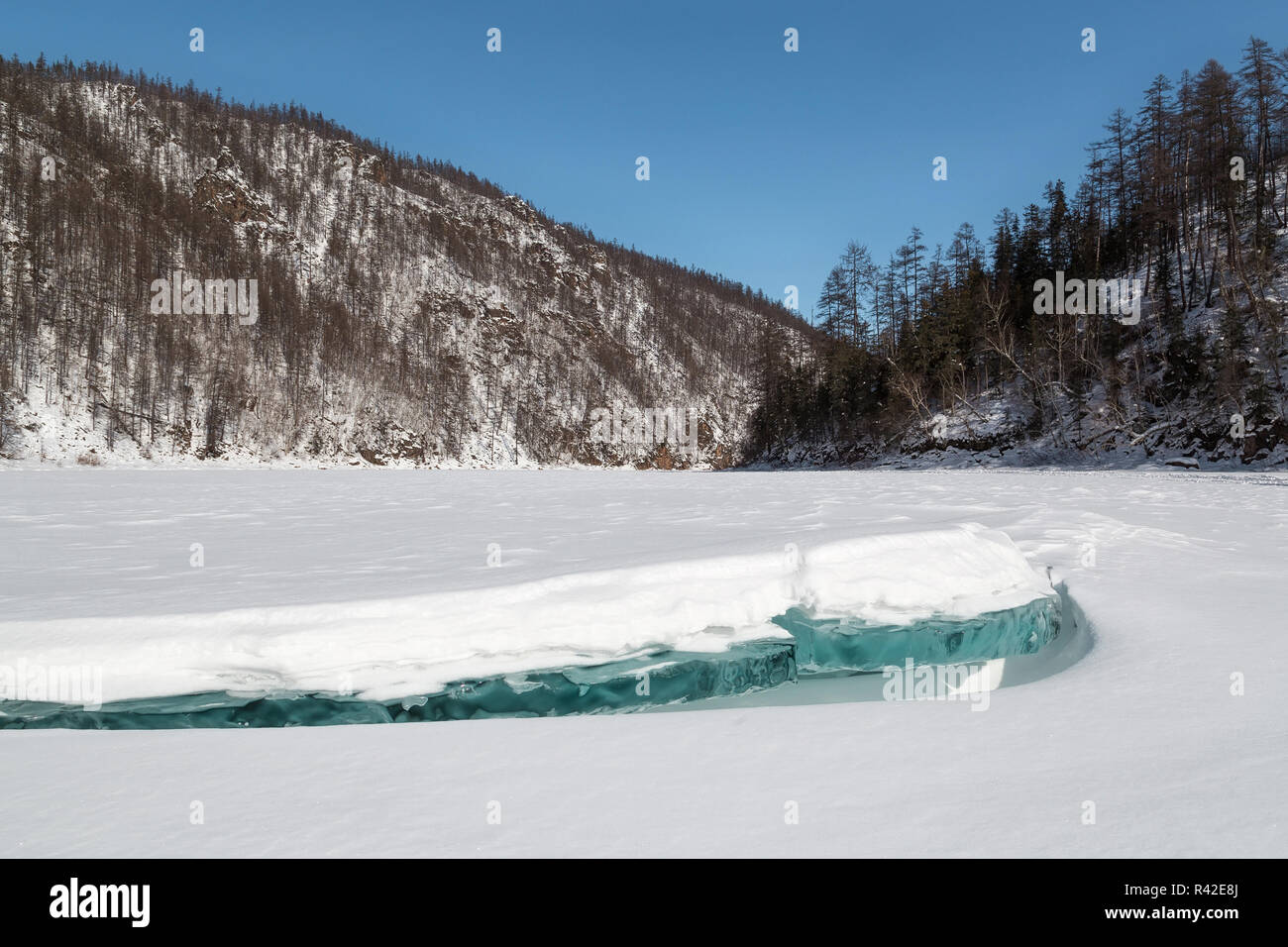 Winter landscape with frozen river and ice floe in the foreground, South Yakutia, Russia Stock Photo