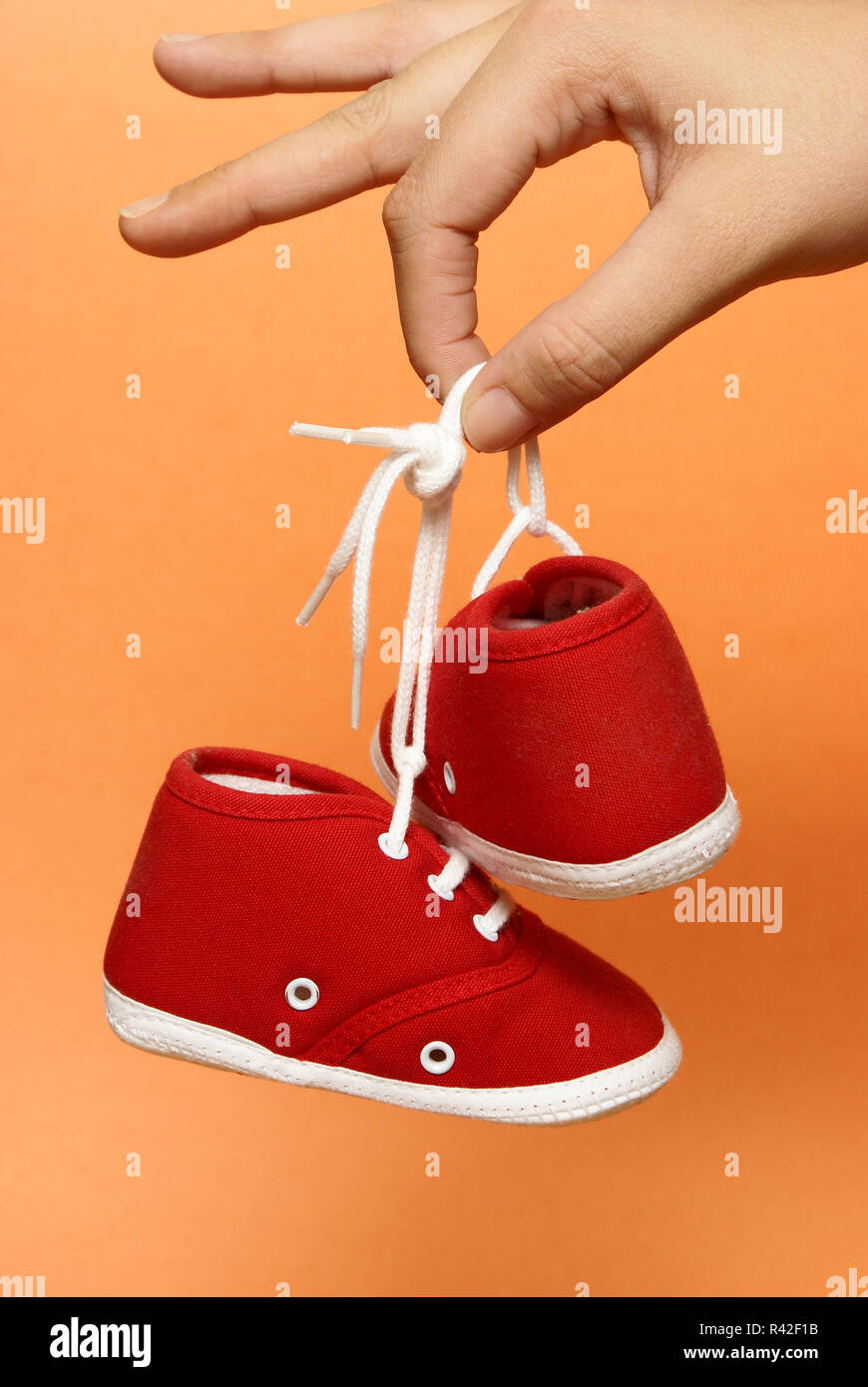 Holding Baby Shoes Stock Photo - Alamy