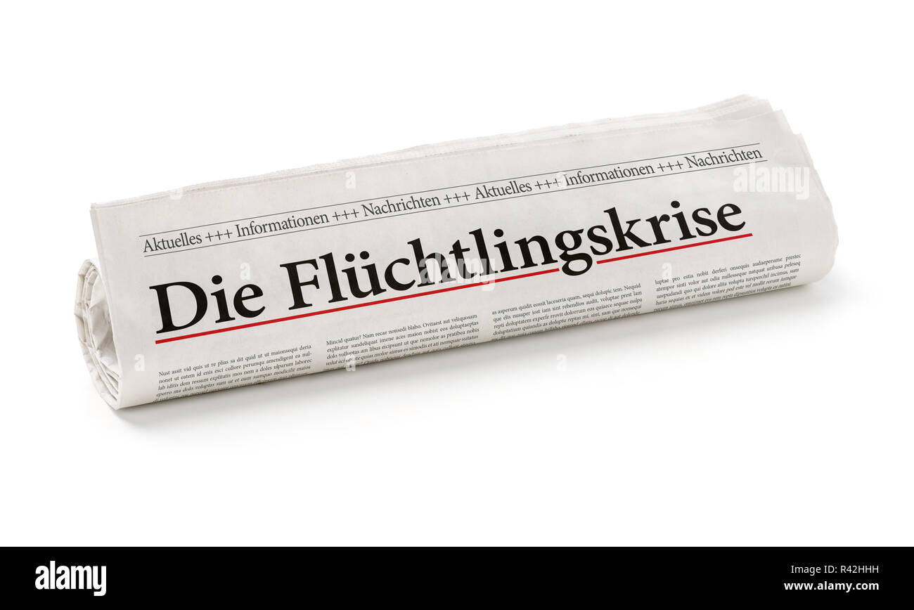 newspaper roll with the heading the refugee crisis Stock Photo