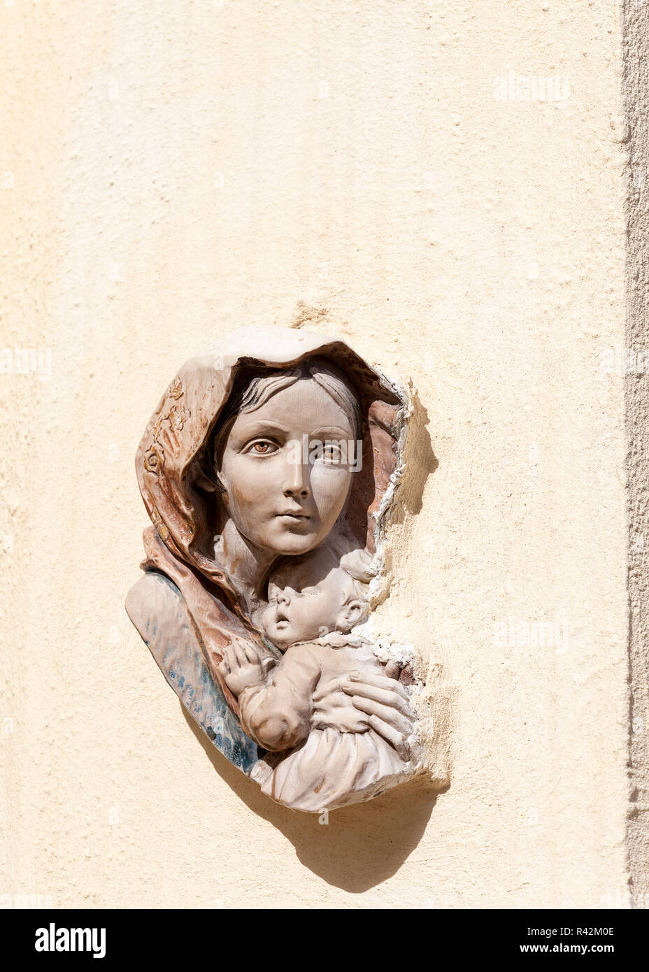 basrelief of the Virgin and Child on the front wall of building in