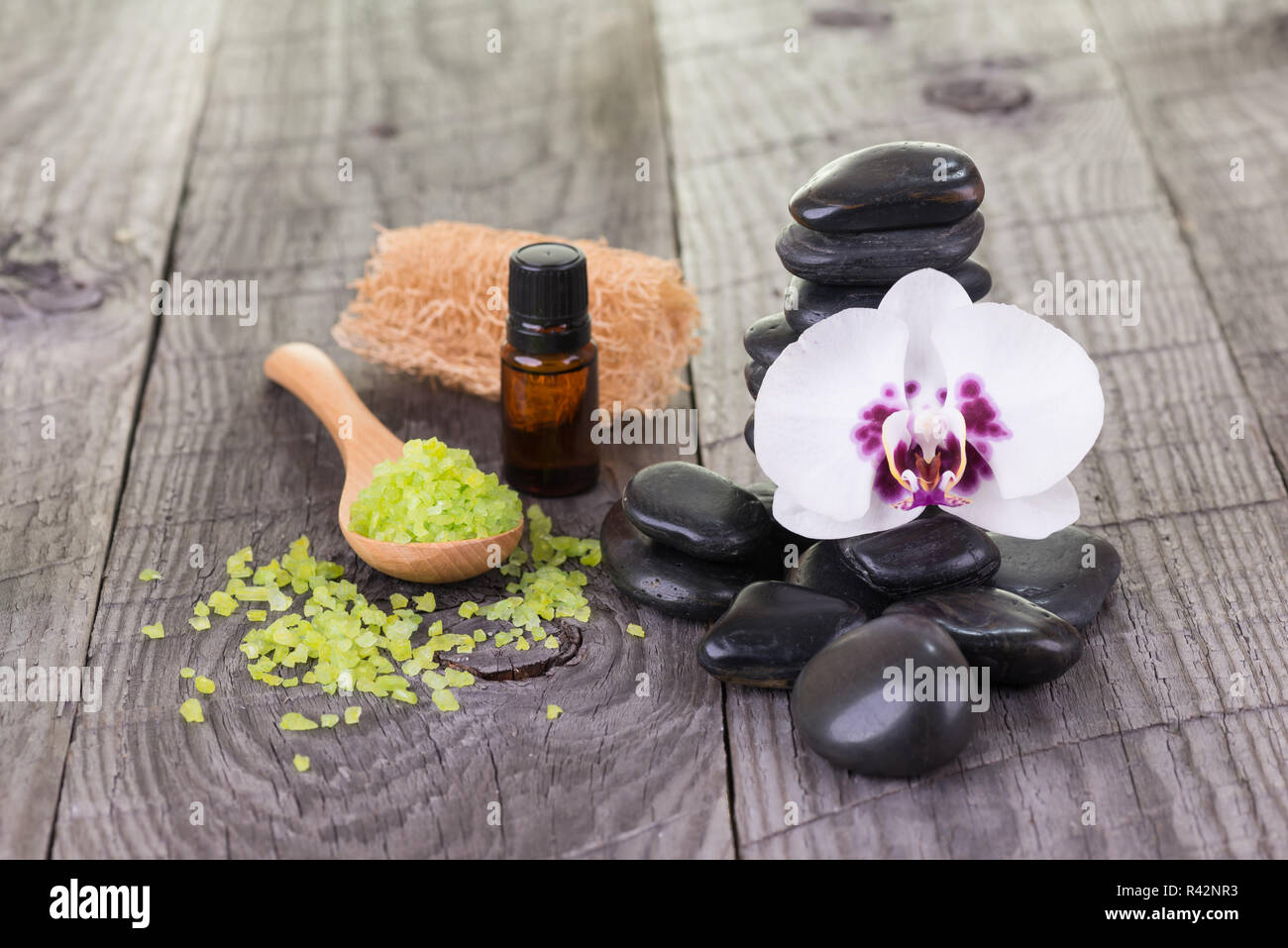 Spa with bath salt, loofah, stones and orchid close-up Stock Photo