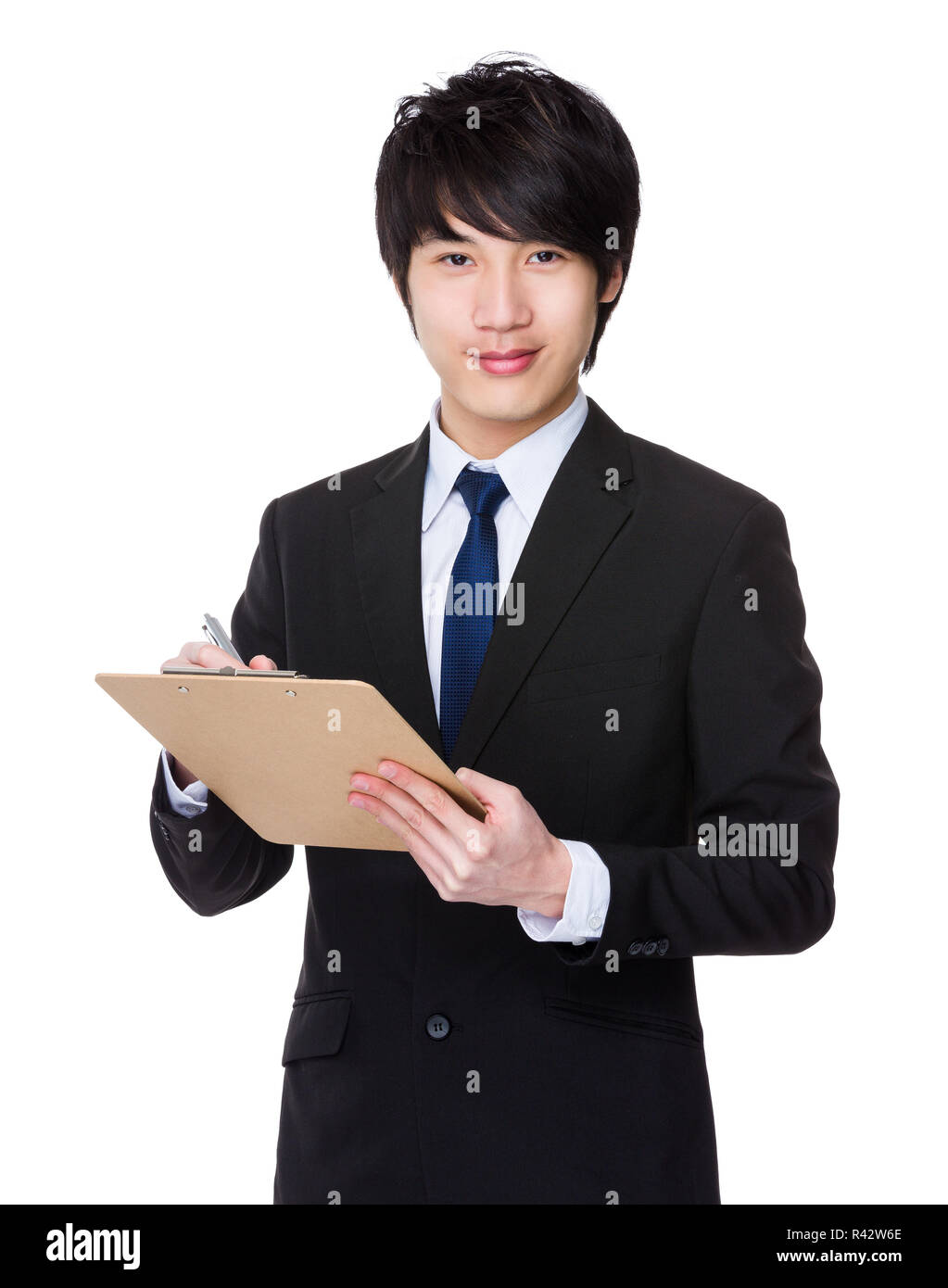 Young Businessman write on clipboard Stock Photo - Alamy