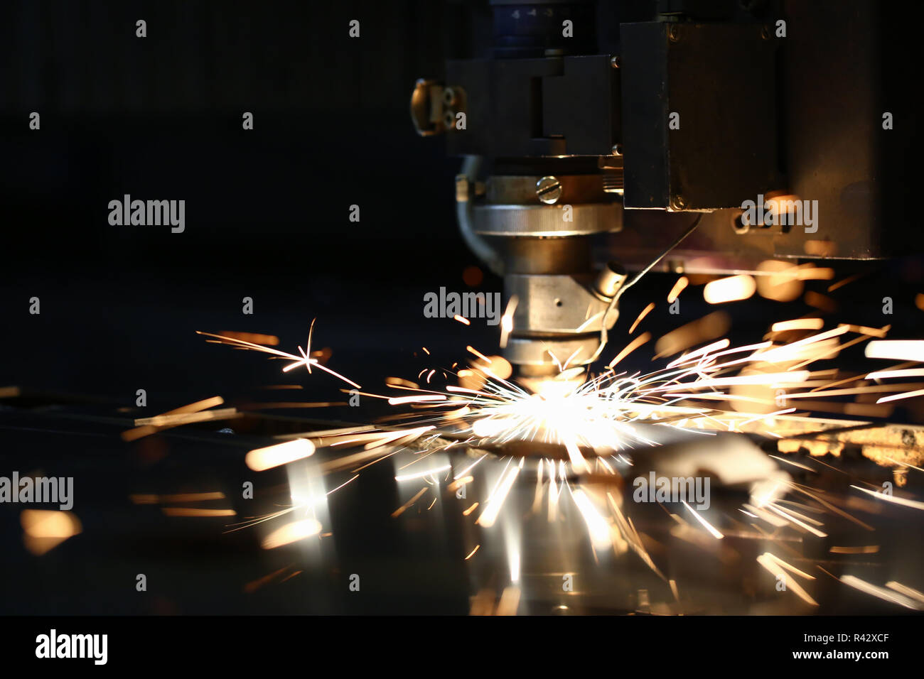 Sparks fly out machine head for metal processing Stock Photo