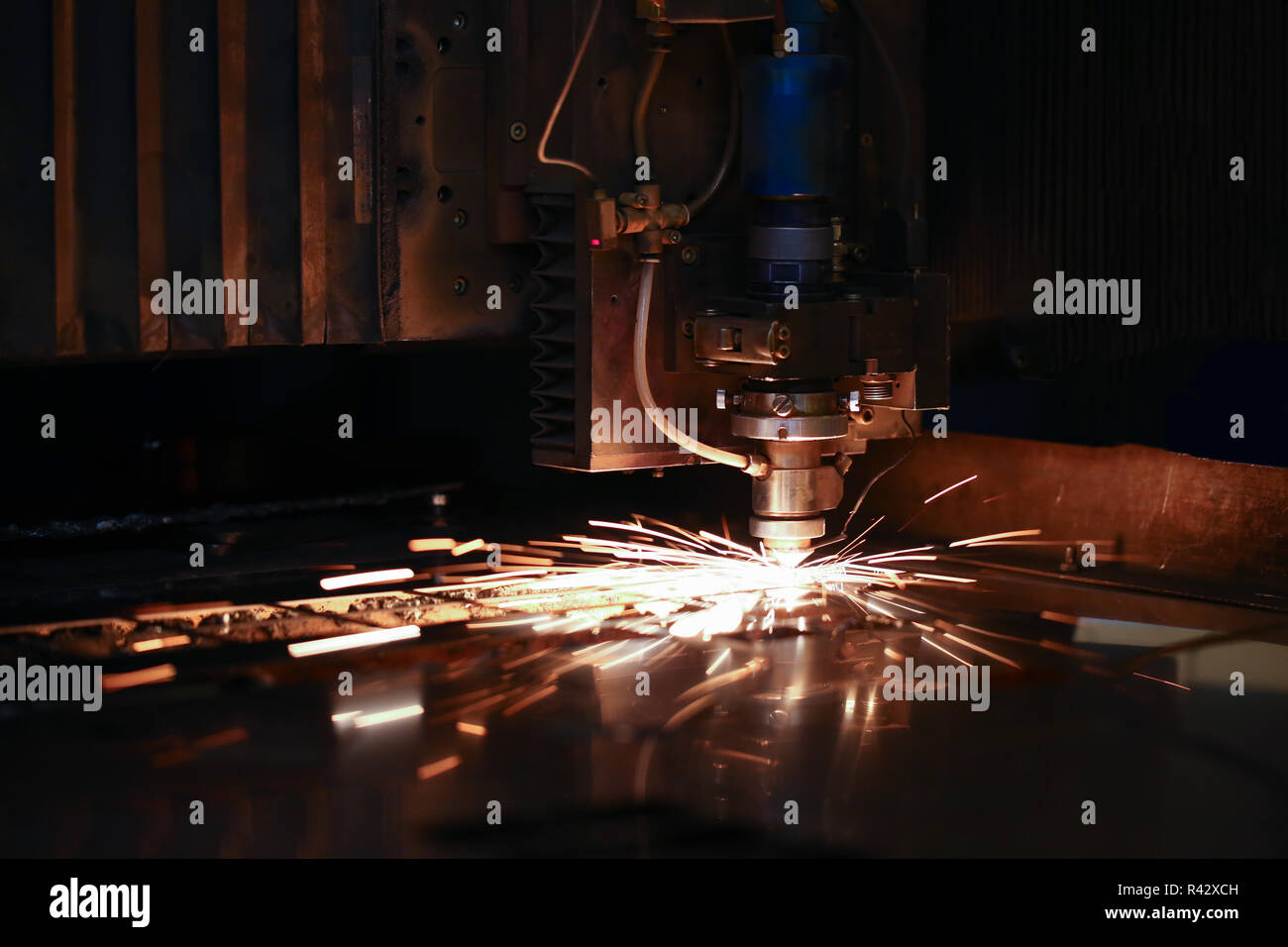 Sparks fly out machine head for metal processing Stock Photo