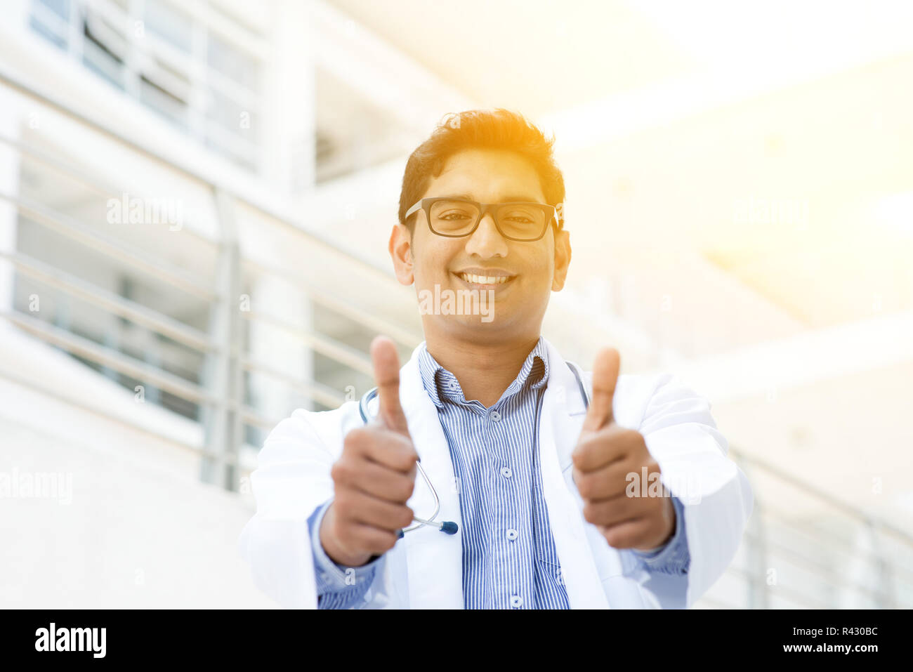Asian Indian medical doctor thumbs up and smiling Stock Photo - Alamy