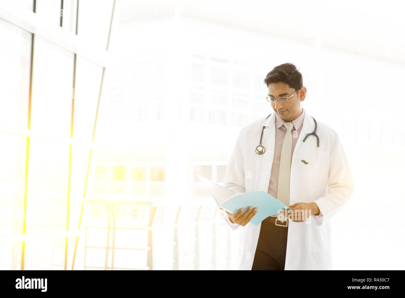 Asian Indian medical doctor reading medical report Stock Photo Alamy