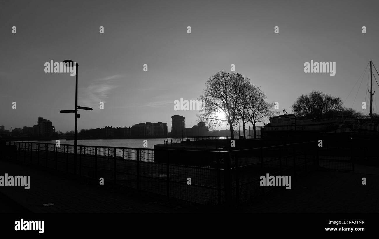 Early autumn morning in South Dock Marina area in London with a view to Canary Wharf area, Sunset. Black and white photo. Stock Photo