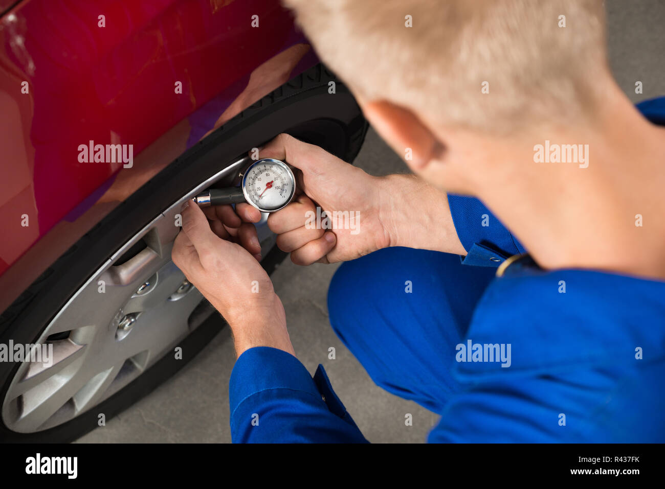 Mechanic Checking Air Pressure Level In Car Tire Stock Photo Alamy