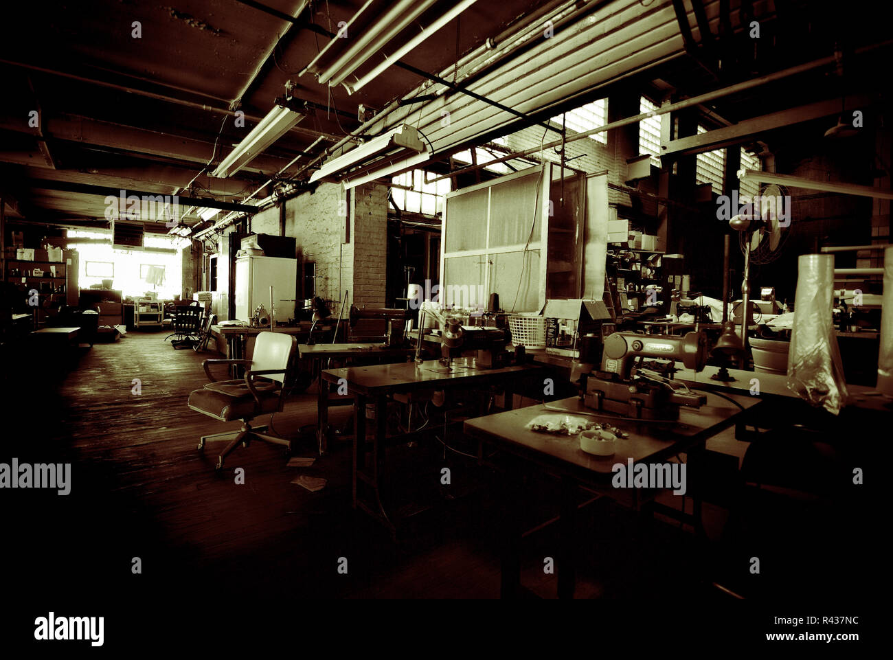 Sewing machine workstations inside a dry cleaning plant Stock Photo Alamy