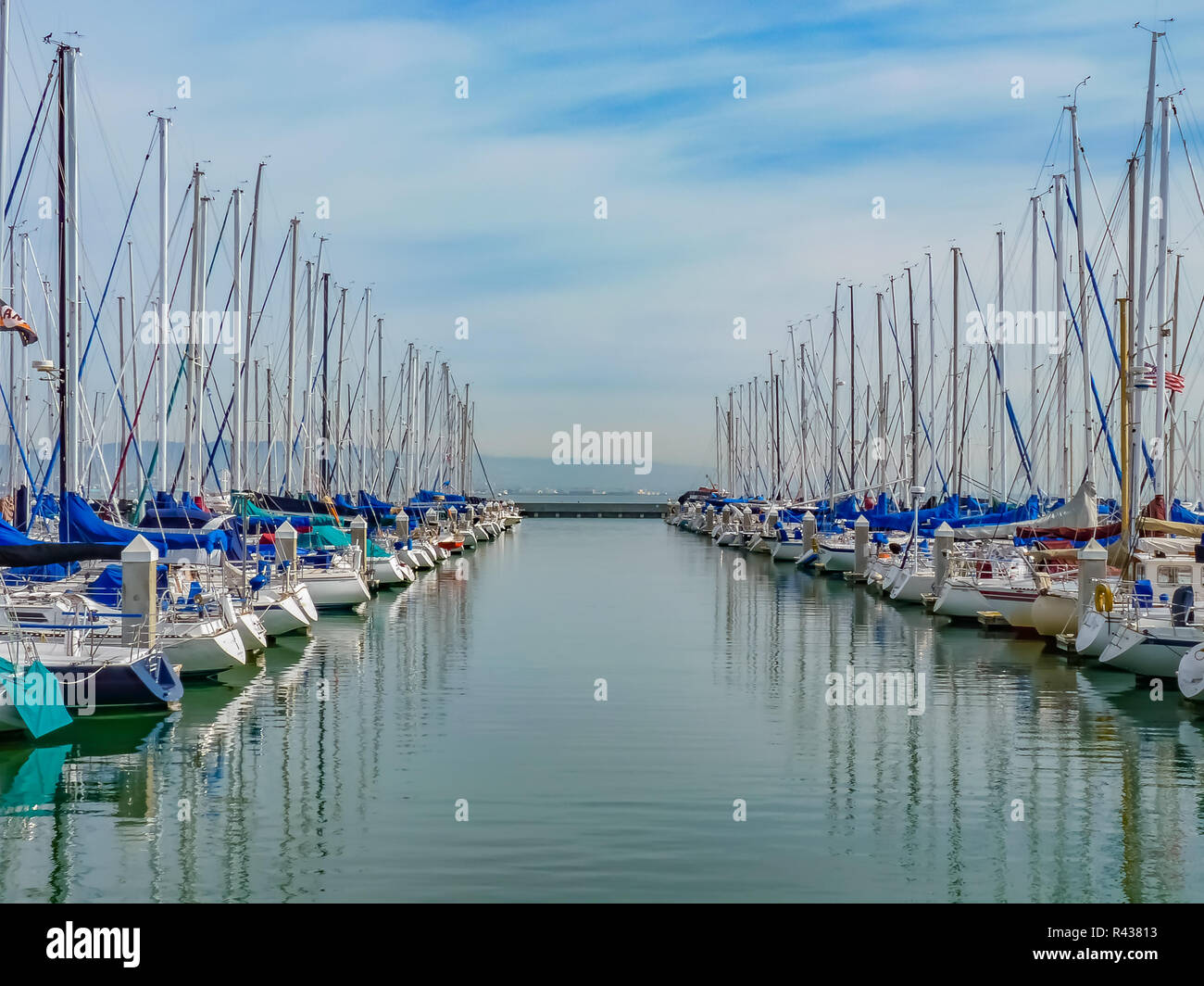 Boats docked at San Francisco South Beach Yacht Club and their reflections in the water Stock Photo