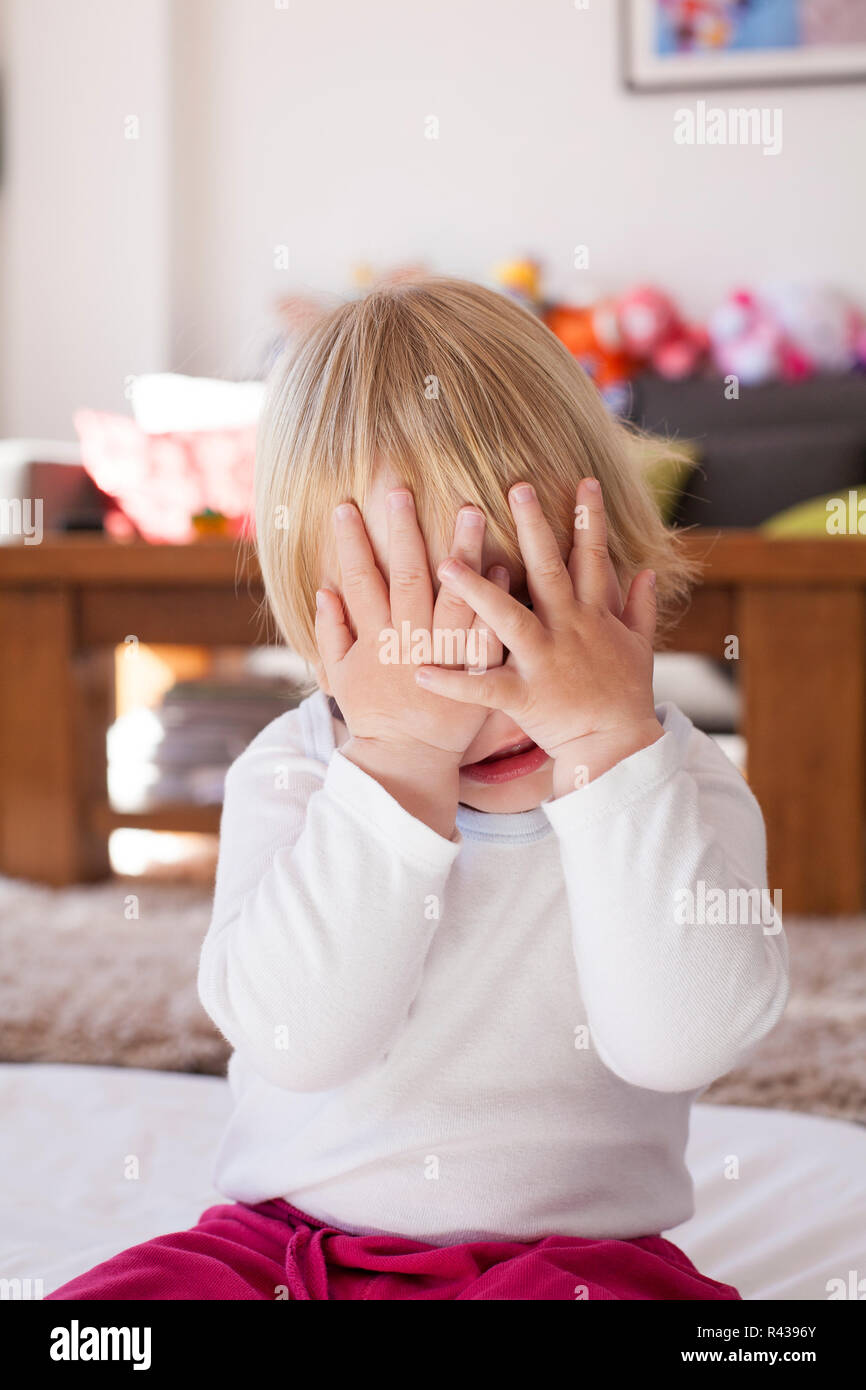 baby hands covering her face Stock Photo Alamy